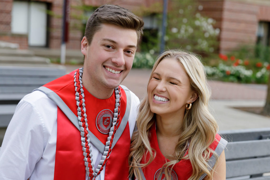 College Graduate couple sitting on WSU campus bench